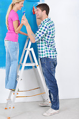 Image showing happy couple paint wall at new home