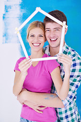 Image showing happy couple paint wall at new home