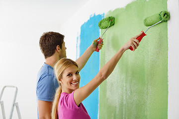 Image showing happy couple paint wall at new home