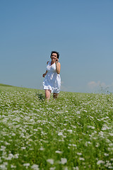 Image showing Young happy woman in green field