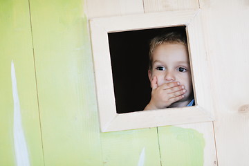 Image showing happy child in a window