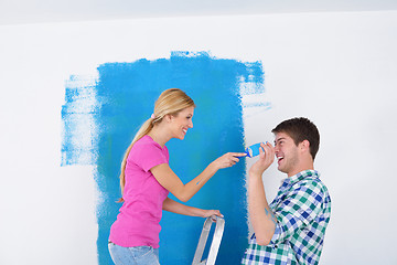 Image showing happy couple paint wall at new home