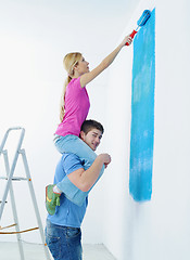 Image showing happy couple paint wall at new home