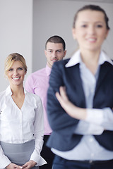 Image showing business woman standing with her staff in background