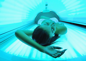 Image showing Beautiful young woman tanning in solarium