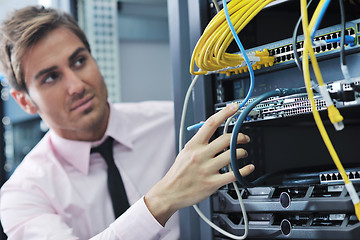 Image showing young it engeneer in datacenter server room