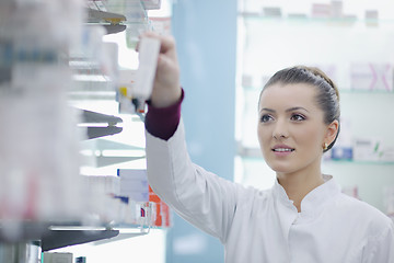 Image showing pharmacist chemist woman standing in pharmacy drugstore