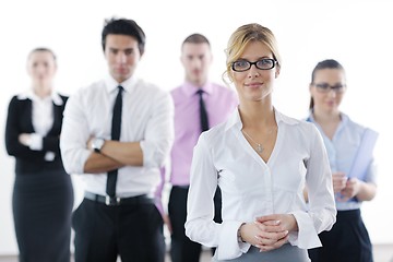 Image showing business woman standing with her staff in background