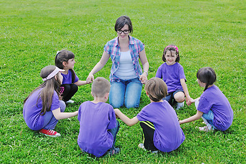 Image showing happy kids group with teacher in nature