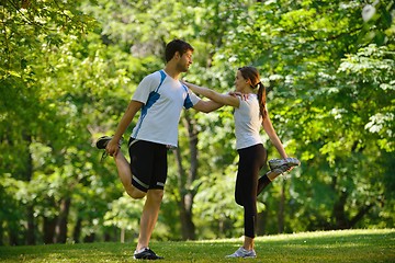 Image showing Couple doing stretching exercise  after jogging