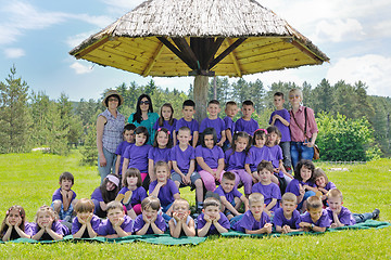 Image showing happy kids group with teacher in nature