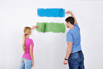 Image showing happy couple paint wall at new home