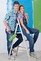 Image showing happy couple paint wall at new home