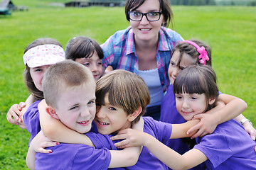 Image showing happy kids group with teacher in nature