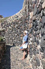 Image showing Greek woman on the streets of Oia, Santorini, Greece