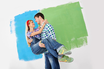 Image showing happy couple paint wall at new home