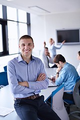 Image showing business man  on a meeting in offce with colleagues in backgroun