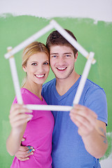 Image showing happy couple paint wall at new home