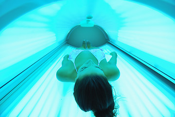 Image showing Beautiful young woman tanning in solarium