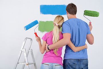 Image showing happy couple paint wall at new home