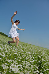 Image showing Young happy woman in green field