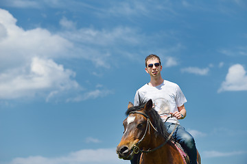 Image showing man ride horse