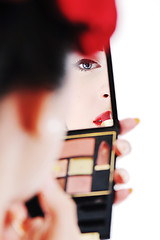 Image showing beautiful young woman applying makeup