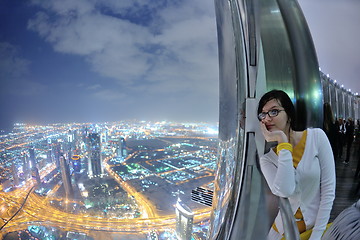 Image showing beautiful woman portrait with big city at night in background