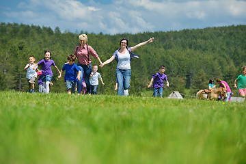 Image showing happy kids group with teacher in nature