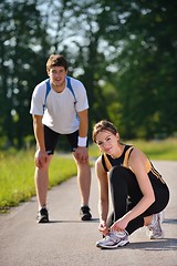 Image showing Couple doing stretching exercise  after jogging