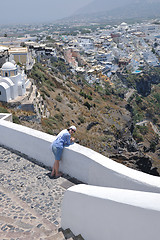 Image showing Greek woman on the streets of Oia, Santorini, Greece