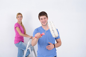 Image showing happy couple paint wall at new home