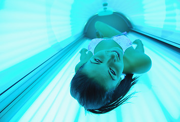 Image showing Beautiful young woman tanning in solarium