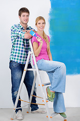 Image showing happy couple paint wall at new home