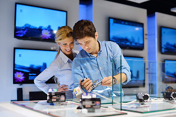 Image showing Young couple in consumer electronics store