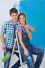 Image showing happy couple paint wall at new home