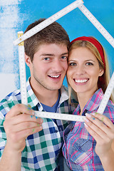 Image showing happy couple paint wall at new home