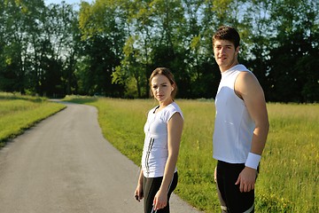 Image showing Couple doing stretching exercise  after jogging