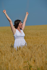 Image showing young woman in wheat field at summer