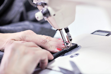 Image showing Hands of Seamstress Using Sewing Machine