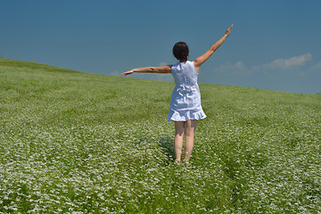 Image showing Young happy woman in green field