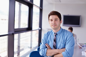 Image showing business man  on a meeting in offce with colleagues in backgroun