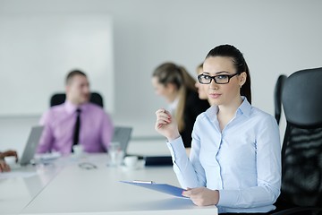 Image showing business woman standing with her staff in background