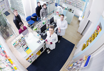 Image showing pharmacist suggesting medical drug to buyer in pharmacy drugstor