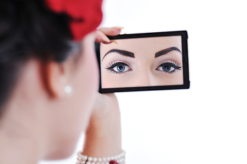 Image showing beautiful young woman applying makeup