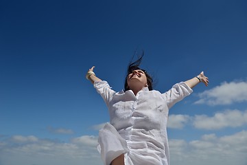 Image showing young woman with spreading arms to sky