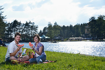 Image showing happy young couple having a picnic outdoor