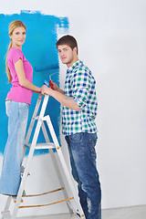 Image showing happy couple paint wall at new home