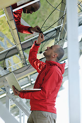 Image showing engineer using laptop at solar panels plant field