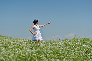 Image showing Young happy woman in green field